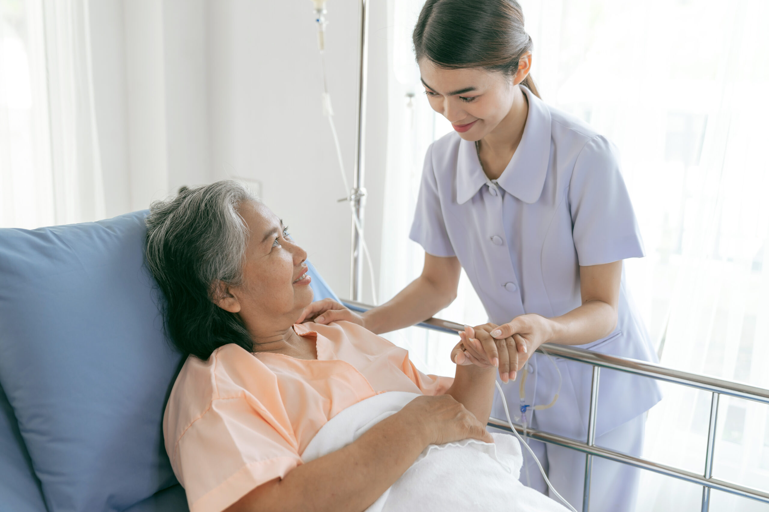 Doctors hold hands to encourage  Elderly senior woman patients in the hospital- senior female medical and healthcare concept
